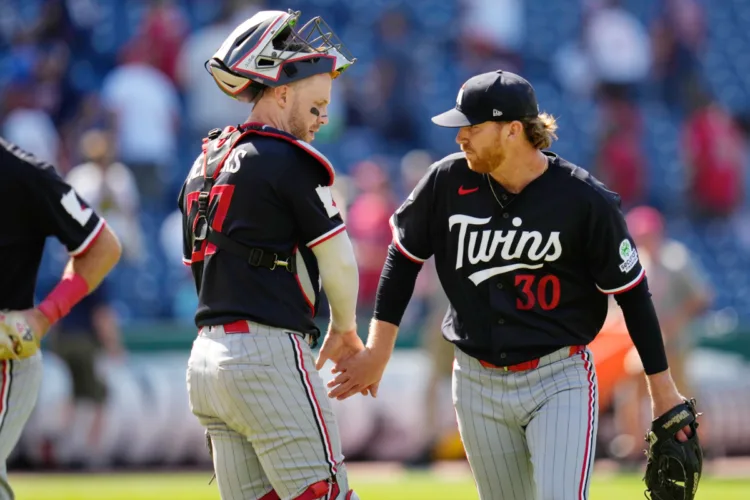 Twins prevail in extras on road